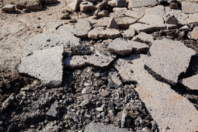 Cracked driveway with potholes