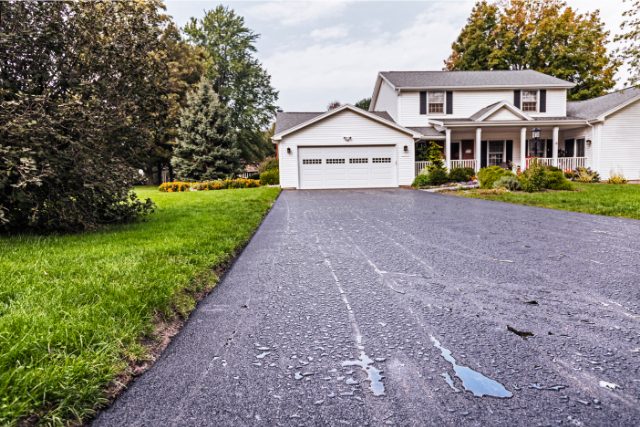 Rain Puddles on New Asphalt Driveway